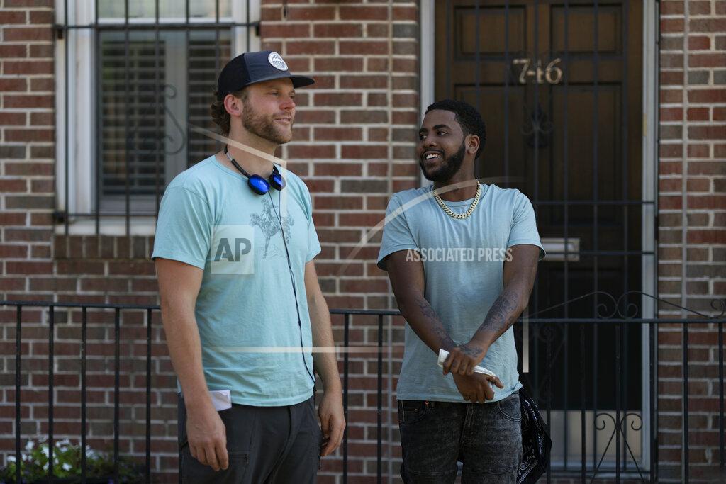 Jessica Kourkounis This image released by Netflix shows director Ricky Staub, left, and Jharrel Jerome on the set of "Concrete Cowboys." (Jessica Kourkounis/Netflix via AP)
