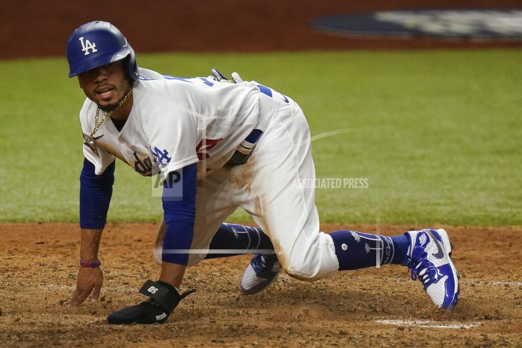 Eric Gay Los Angeles Dodgers' Mookie Betts scores on a fielders choice by Max Muncy during the fifth inning in Game 1 of the baseball World Series against the Tampa Bay Rays Tuesday, Oct. 20, 2020, in Arlington, Texas. (AP Photo/Eric Gay)