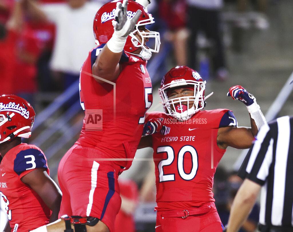 Eric Zamora Fresno State's Netane Muti, left, celebrates a touchdown by Ronnie Rivers, right, against Minnesota during an NCAA college football game Saturday, Sept. 7, 2019, in Fresno, Calif. (Eric Paul Zamora/The Fresno Bee via AP)