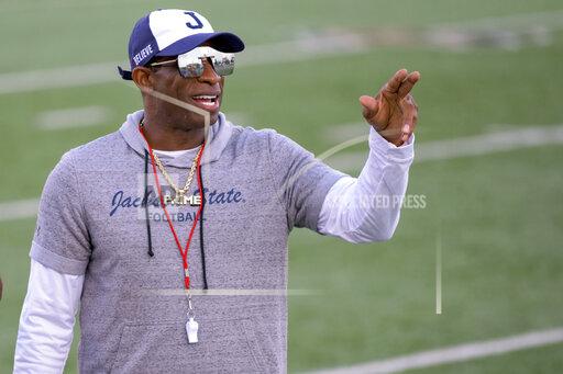 FILE - Jackson State head coach Deion Sanders points during an NCAA football game against Louisiana Monroe on Saturday, Sept. 18, 2021, in Monroe, La. Deion Sanders has been all over national TV, putting Jackson State in the spotlight every time his insurance commercials air. Hiring Eddie George has had a similar effect at Tennessee State. (AP Photo/Matthew Hinton, File)