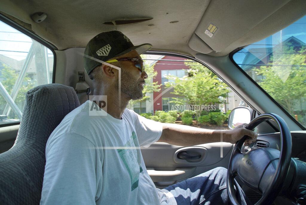 Allen G. Breed Alton Lucas drives home after dropping some firewood at a local convenience store outside of Raleigh, N.C., on Friday, June 18, 2021. “I started the landscaping company, to be honest with you, because nobody would hire me because I have a felony,” said Lucas, whose business got off the ground with the help of Inmates to Entrepreneurs, a national nonprofit assisting people with criminal backgrounds by providing practical entrepreneurship education. (AP Photo/Allen G. Breed)