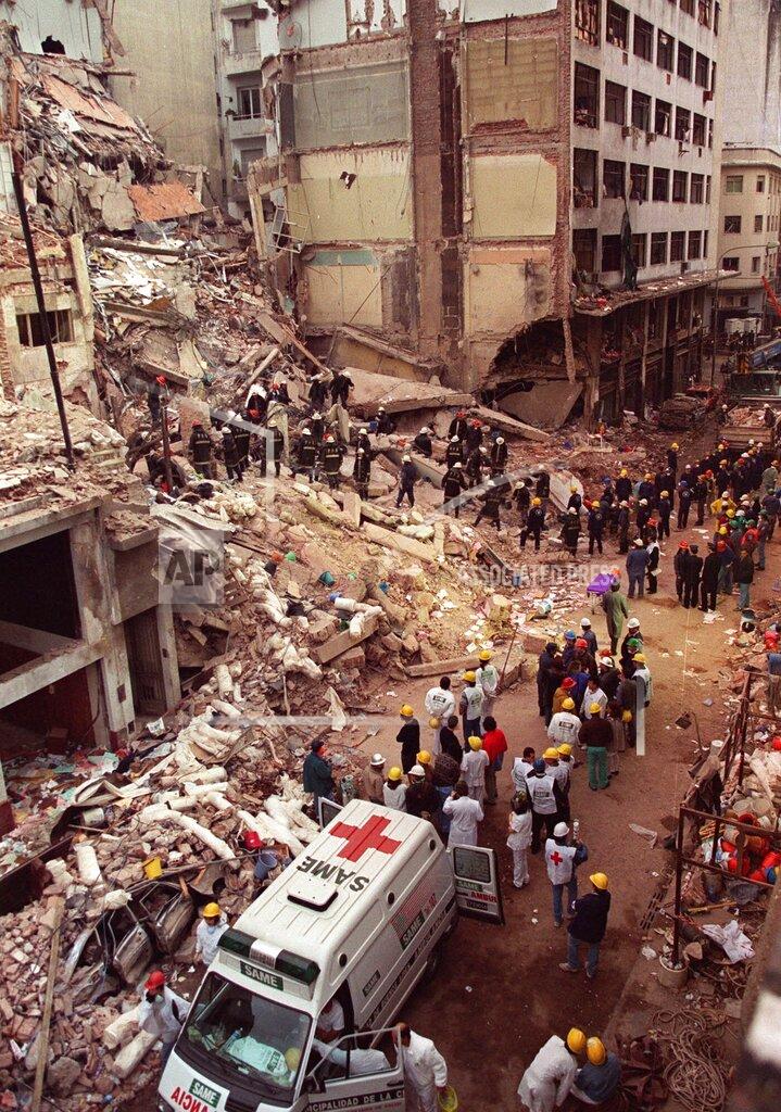Alejandro Pagni FILE - In this July 18, 1994 file photo, firefighters and rescue workers search through the rubble of the Buenos Aires Jewish Community center after a car bomb destroyed the building, killing 85 people. A court on Wednesday, Dec. 23, 2020, has cleared Carlos Telleldin, the only Argentine still facing charges in the bombing. (AP Photo/Alejandro Pagni, File)