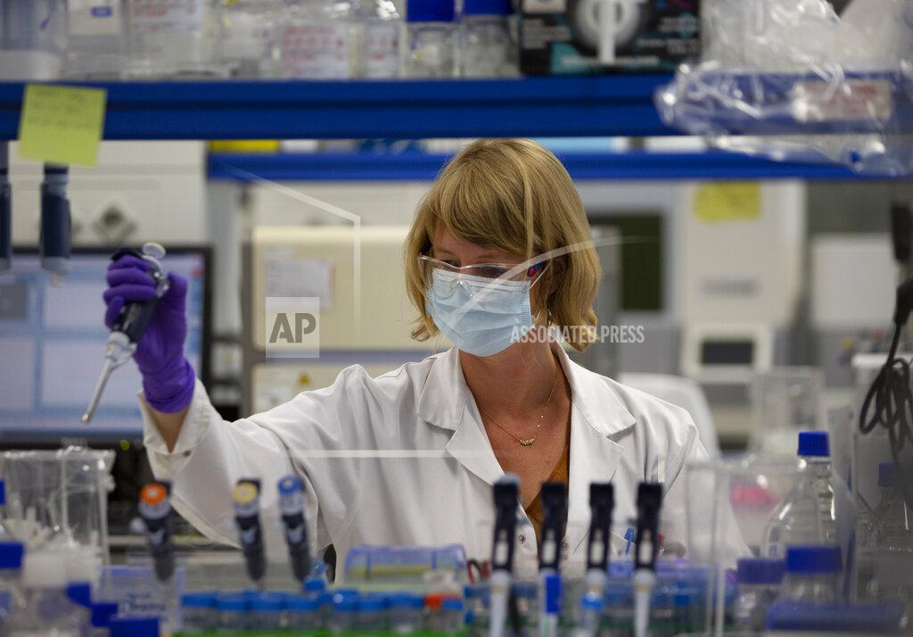 A lab technician works during research on coronavirus, COVID-19, at Johnson & Johnson subsidiary Janssen Pharmaceutical in Beerse, Belgium, Wednesday, June 17, 2020. Janssen Pharmaceutical hopes to begin clinical trials on a potential vaccine for COVID-19 in the middle of the summer. (AP Photo/Virginia Mayo)