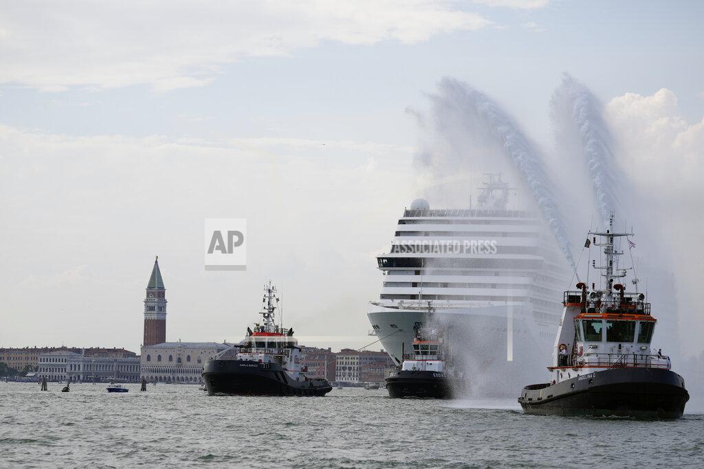 Antonio Calanni The the 92,409-ton, 16-deck MSC Orchestra cruise ship exits the lagoon as St. Mark's Square stands out in background, left, as it leaves Venice, Italy, Saturday, June 5, 2021. The first cruise ship leaving Venice since the pandemic is set to depart Saturday amid protests by activists demanding that the enormous ships be permanently rerouted out the fragile lagoon, especially Giudecca Canal through the city's historic center, due to environmental and safety risks. (AP Photo/Antonio Calanni)