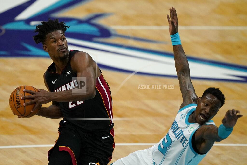 Chris Carlson Miami Heat forward Jimmy Butler drives to the basket past Charlotte Hornets guard Terry Rozier during the first half of an NBA basketball game on Sunday, May 2, 2021, in Charlotte, N.C. (AP Photo/Chris Carlson)