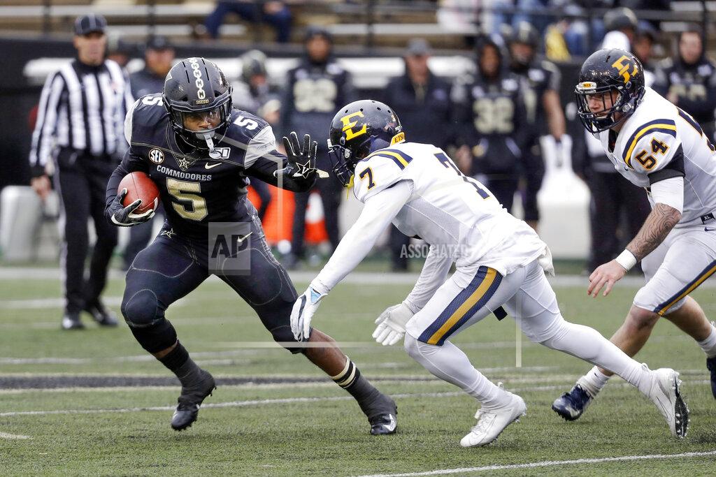 Mark Humphrey Vanderbilt running back Ke'Shawn Vaughn (5) tries to move past ETSU defensive back Quinn Smith (7) in the first half of an NCAA college football game Saturday, Nov. 23, 2019, in Nashville, Tenn. (AP Photo/Mark Humphrey)