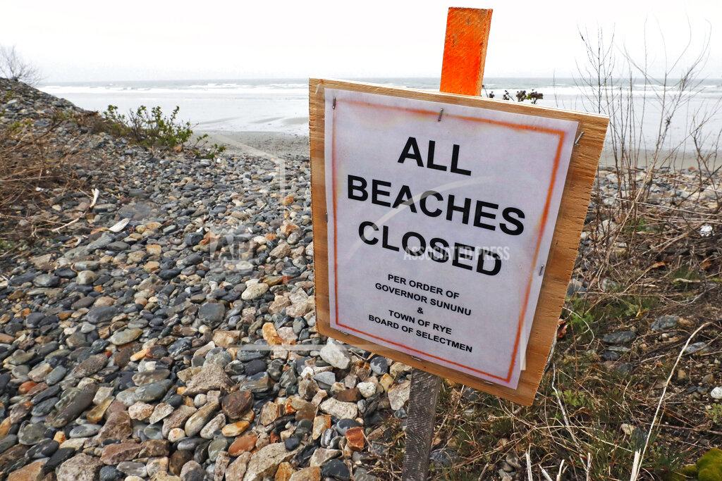 Charles Krupa A sign notifies visitors that the beach is closed, due to the COVID-19 virus outbreak, in Rye, N.H., Thursday, April 30, 2020. (AP Photo/Charles Krupa)