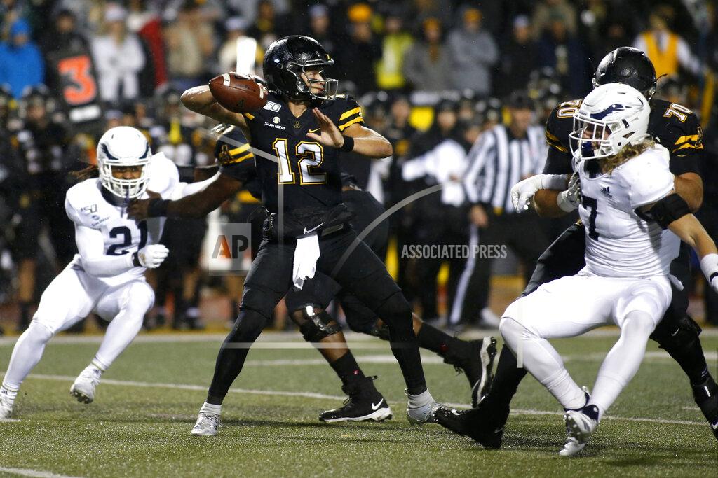 Brian Blanco Appalachian State quarterback Zac Thomas (12) looks for an open receiver while getting pressure from Georgia Southern linebacker Lane Ecton (7) during the first half of an NCAA college football game Thursday, Oct. 31, 2019, in Boone, N.C. (AP Photo/Brian Blanco)