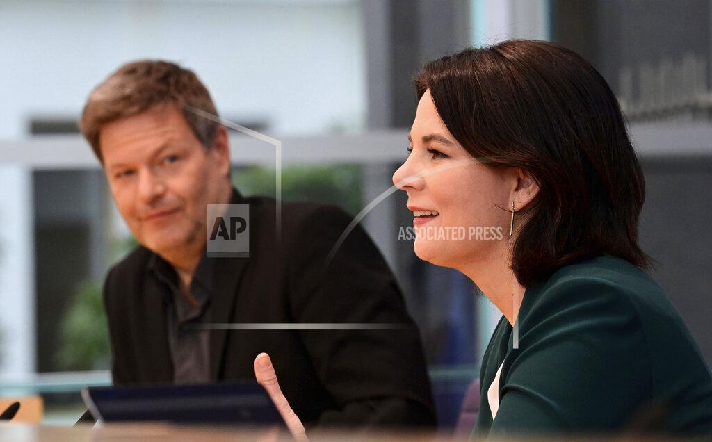 Tobias Schwarz The leaders of Germany's Green party Annalena Baerbock, right, and Robert Habeck attend a press conference on Monday, March 15, 2021 in Berlin, Germany, one day after regional elections in the federal states of Rhineland-Palatinate and Baden-Wuerttemberg. (Tobias Schwarz/Pool via AP)