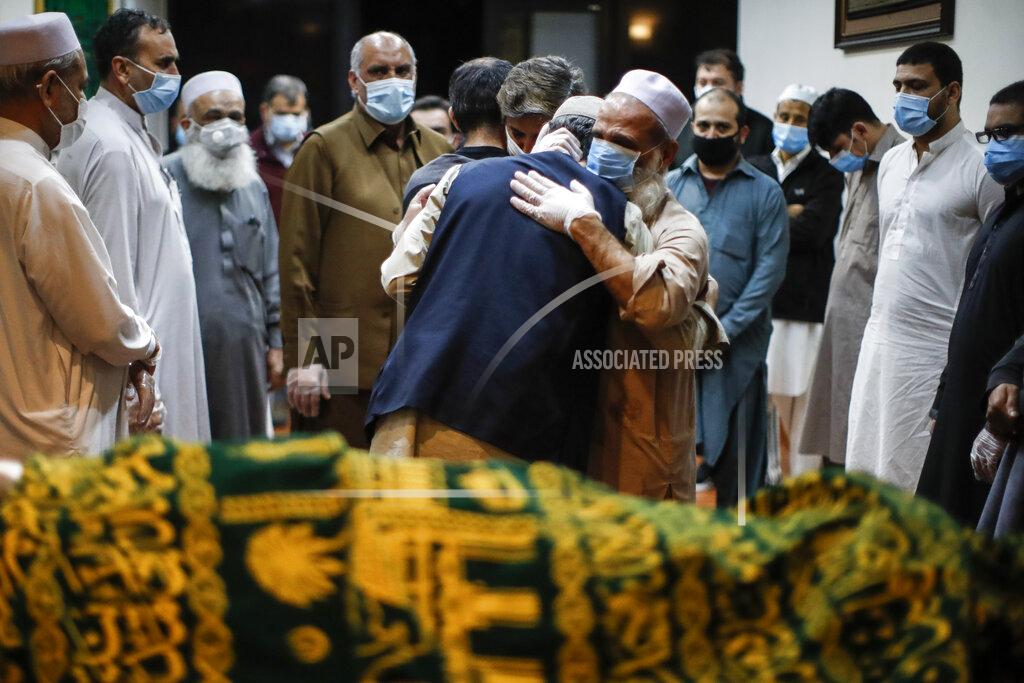 John Minchillo FILE - In this May 17, 2020, file photo, Mohammad Ayaz, cousin of Mohammad Altaf, center right, is hugged by a mourner after funeral prayers are given over Altaf's body at Al-Rayaan Muslim Funeral Services in the Brooklyn borough of New York. The U.S. death toll from COVID-19 has topped 500,000 — a number so staggering that a top health researchers says it is hard to imagine an American who hasn't lost a relative or doesn't know someone who died. (AP Photo/John Minchillo)