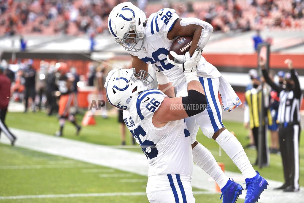 David Richard Indianapolis Colts offensive guard Quenton Nelson (56) picks up running back Jonathan Taylor (28) after Taylor scored a four-yard touchdown during the first half of an NFL football game against the Cleveland Browns, Sunday, Oct. 11, 2020, in Cleveland. (AP Photo/David Richard)