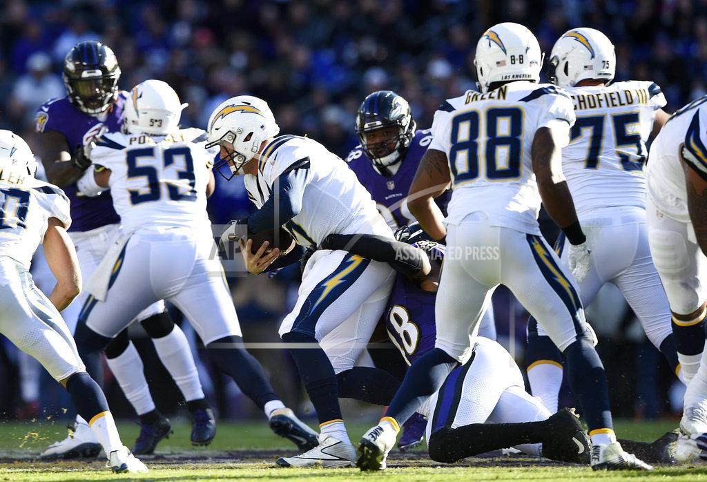 Gail Burton Los Angeles Chargers quarterback Philip Rivers, center, is sacked by Baltimore Ravens inside linebacker Patrick Onwuasor (48) in the first half of an NFL wild card playoff football game, Sunday, Jan. 6, 2019, in Baltimore. (AP Photo/Gail Burton)