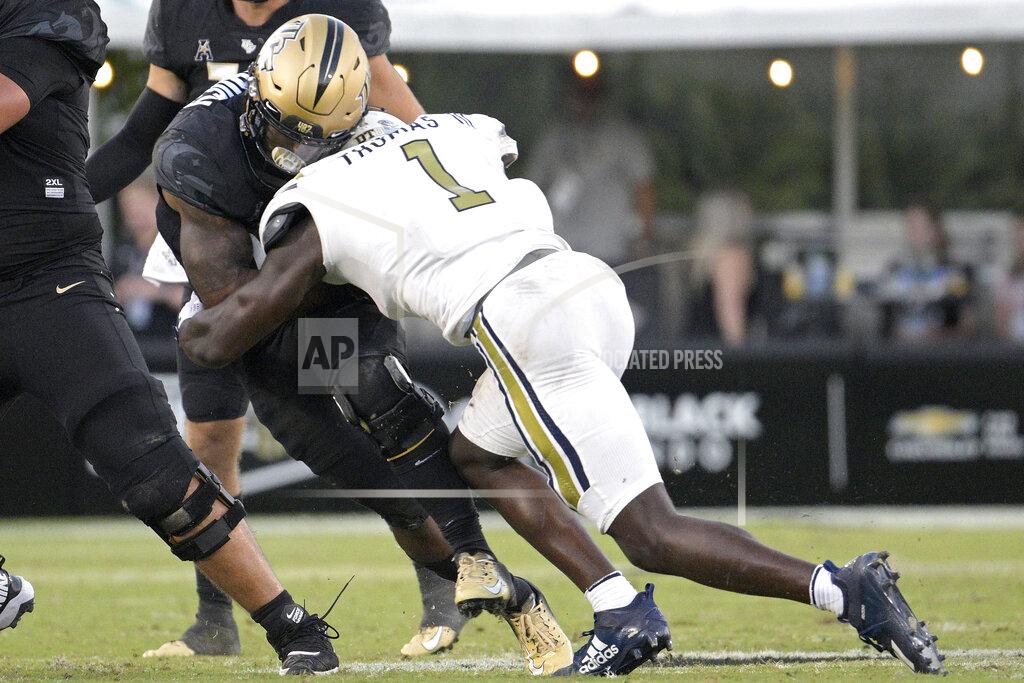 Phelan M. Ebenhack Central Florida running back RJ Harvey, left, is tackled by Georgia Tech linebacker Charlie Thomas (1) after rushing for yardage during the second half of an NCAA college football game, Saturday, Sept. 24, 2022, in Orlando, Fla. Thomas was penalized for targeting on the play and was disqualified from the game. (AP Photo/Phelan M. Ebenhack)