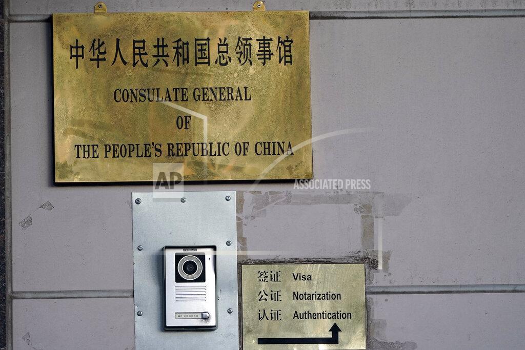 David J. Phillip A sign directs visitors outside the Chinese Consulate General Wednesday, July 22, 2020, in Houston. Houston police and fire officials responded to reports that documents were being burned in the courtyard of the consulate Tuesday night, according to the Houston Police Department. China says the U.S. has ordered it to close its consulate in Houston in what it called a provocation that violates international law. (AP Photo/David J. Phillip)