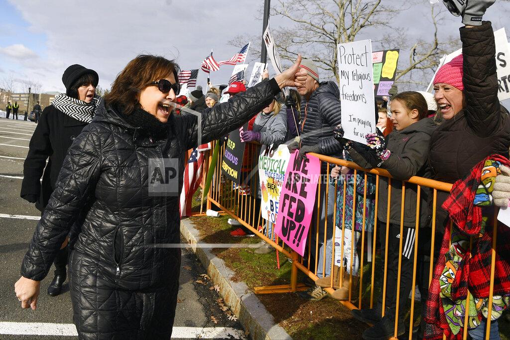 Jessica Hill State Rep. Anne Dauphinais, R-Killingly, greets protesters on the State Capitol grounds, Wednesday, Jan. 6, 2021, in Hartford, Conn. The new legislative session is expected to focus on the continuing coronavirus pandemic and the state's budget challenges. (AP Photo/Jessica Hill)
