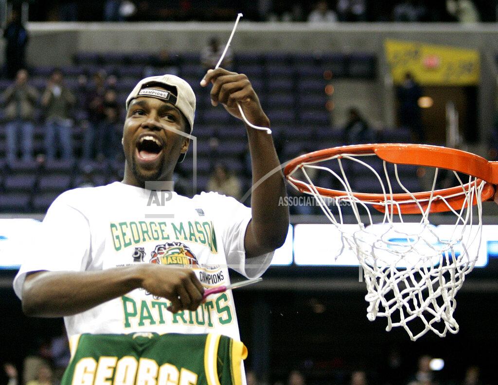Haraz N. Ghanbari FILE - In this March 26, 2006, file photo, George Mason's Folarin Campbell cuts the net after beating Connecticut 86-84 in overtime during the fourth round of the NCAA college basketball tournament in Washington. (AP Photo/Haraz N. Ghanbari, File)