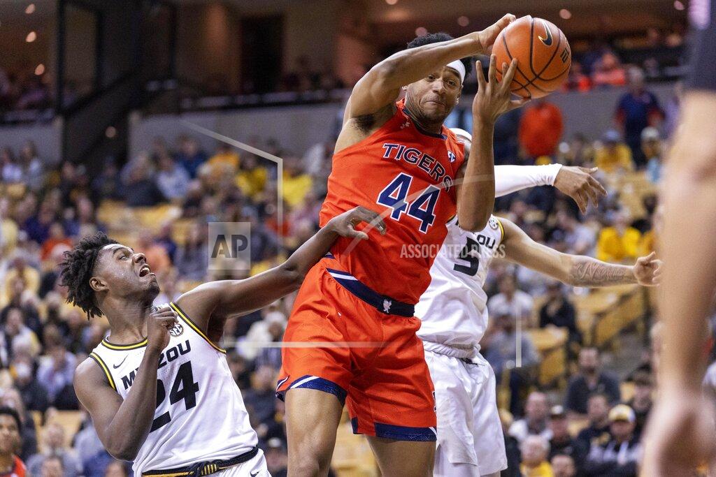 L.g. Patterson Auburn's Dylan Cardwell, center, pulls down a rebound in front of Missouri's Kobe Brown, left, and Jarron Coleman, right, during the first half of an NCAA college basketball game Tuesday, Jan. 25, 2022, in Columbia, Mo. (AP Photo/L.G. Patterson)