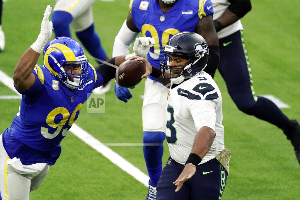 Jae C. Hong Seattle Seahawks quarterback Russell Wilson (3) throws under pressure from Los Angeles Rams defensive end Aaron Donald (99) during the second half of an NFL football game Sunday, Nov. 15, 2020, in Inglewood, Calif. (AP Photo/Jae C. Hong)