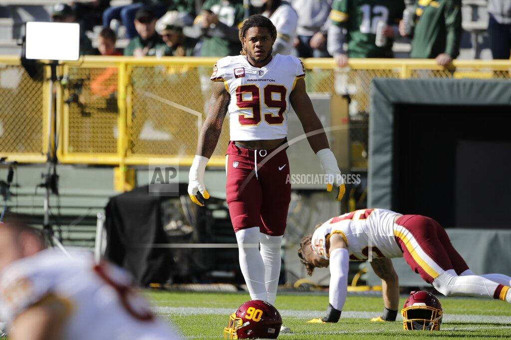 Aaron Gash Washington Football Team's Chase Young warms up before an NFL football game against the Green Bay Packers Sunday, Oct. 24, 2021, in Green Bay, Wis. (AP Photo/Aason Gash)