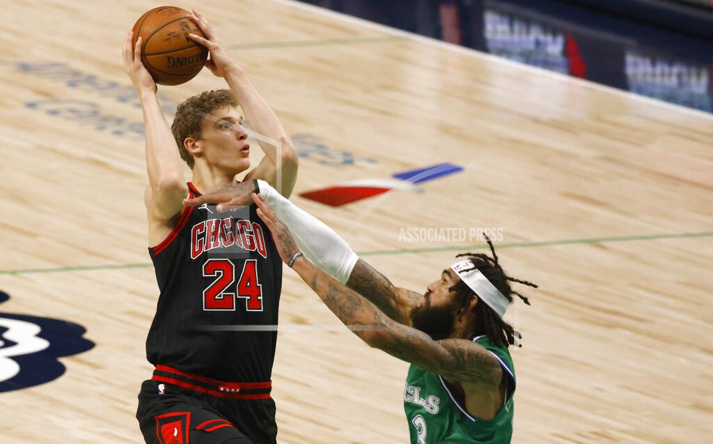 Ron Jenkins Chicago Bulls forward Lauri Markkanen (24) shoots over Dallas Mavericks center Willie Cauley-Stein (33) during the first half of an NBA basketball game, Sunday, Jan. 17, 2021, in Dallas. (AP Photo/Ron Jenkins)