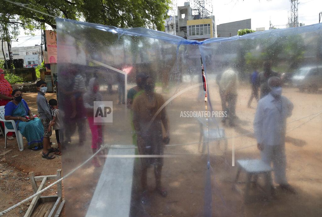 People wait in a queue to register their names before giving their nasal swab samples to test for COVID-19 in Hyderabad, India, Saturday, Aug. 22, 2020. India has the third-highest caseload after the United States and Brazil, and the fourth-highest death toll in the world. (AP Photo/Mahesh Kumar A.)