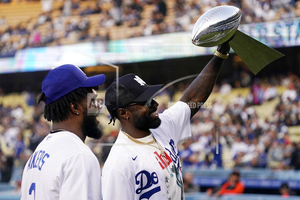 Mark J. Terrill Los Angeles Rams safety Nick Scott, right, holds up the Vince Lombardi Trophy for fans as running back Cam Akers stands by while members of the Rams visited prior to a baseball game between the Los Angeles Dodgers and the San Francisco Giants Tuesday, May 3, 2022, in Los Angeles. (AP Photo/Mark J. Terrill)
