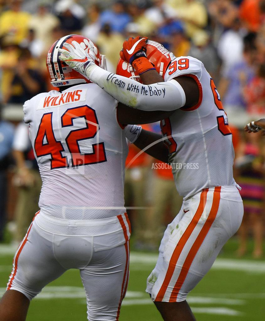 Jon Barash FILE - In this Sept. 22, 2018, file photo, Clemson defensive end Clelin Ferrell (99) celebrates his touchdown against Georgia Tech with Clemson defensive lineman Christian Wilkins (42) during the first half of an NCAA college football game, in Atlanta. Ferrell fidgets in his seat, knowing how close _ and how far away _ to achieving what he returned to Clemson to capture: The national championship. Wilkins is grateful for the journey he has taken during his final college season. But he says he hasn’t reached his destination yet. The second-ranked Tigers take on No. 1 Alabama for the national title on Monday night, Jan. 7, 2019. (AP Photo/Jon Barash, File)