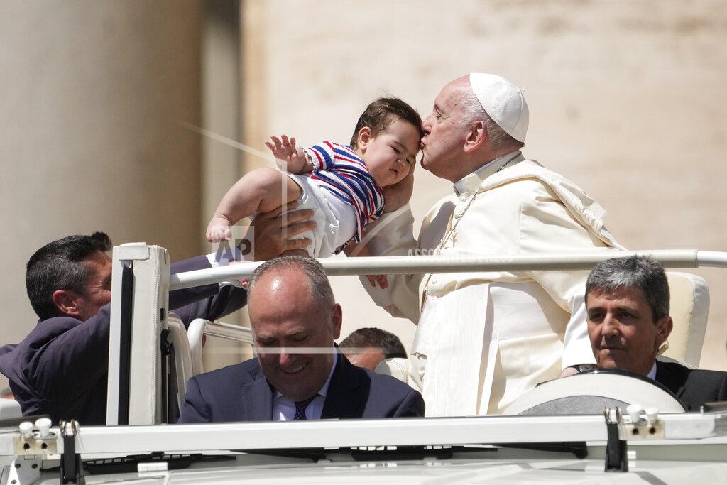 Andrew Medichini Pope Francis kisses a baby as he leaves at the end of his weekly general audience in St. Peter's Square, at the Vatican, Wednesday, May 25, 2022. (AP Photo/ Andrew Medichini)
