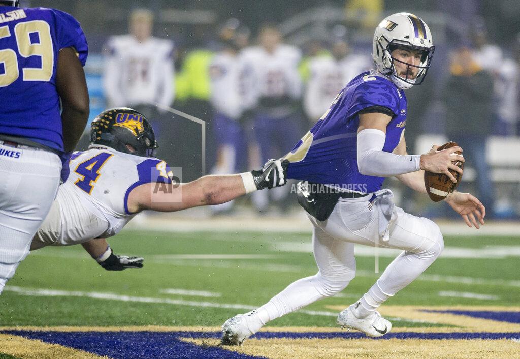 Daniel Lin Northern Iowa defensive lineman Jared Brinkman (44) grabs onto James Madison quarterback Ben DiNucci (6) during the first half of a quarterfinal game in the NCAA college Football Championship Subdivision playoffs in Harrisonburg, Va., Friday, Dec. 13, 2019. (Daniel Lin/Daily News-Record via AP)