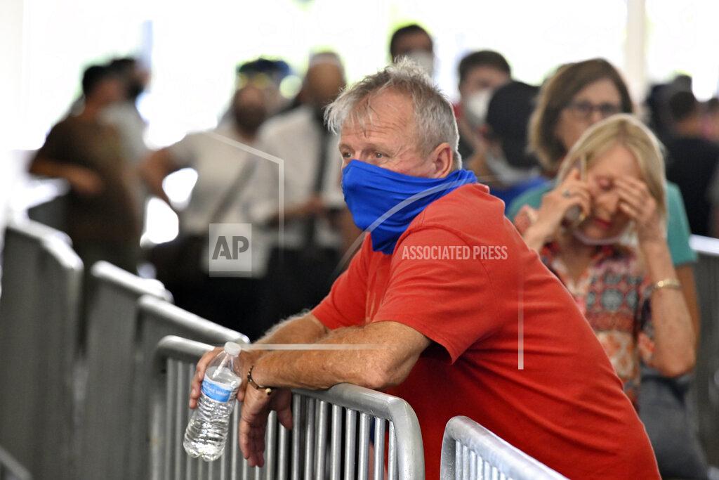Timothy D. Easley A voter waits in line at Kroger Field to cast his ballot in the Kentucky primary in Lexington, Ky., Tuesday, June 23, 2020. At one point the wait to get to the voting area was over 90 minutes. (AP Photo/Timothy D. Easley)
