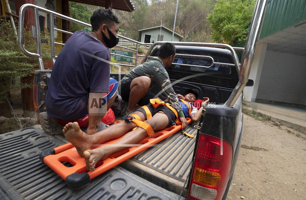 Sakchai Lalit An injured Karen villager from Myanmar is transported at Ban Mae Sam Laep Health Center, Mae Hong Son province, northern Thailand, after crossing Salawin river on a boat, on Tuesday March 30, 2021. The weekend strikes by the Myanmar military, which sent ethnic Karen people seeking safety in Thailand, represented another escalation in the violent crackdown by Myanmar’s junta on protests of its Feb. 1 takeover.(AP Photo/Sakchai Lalit)