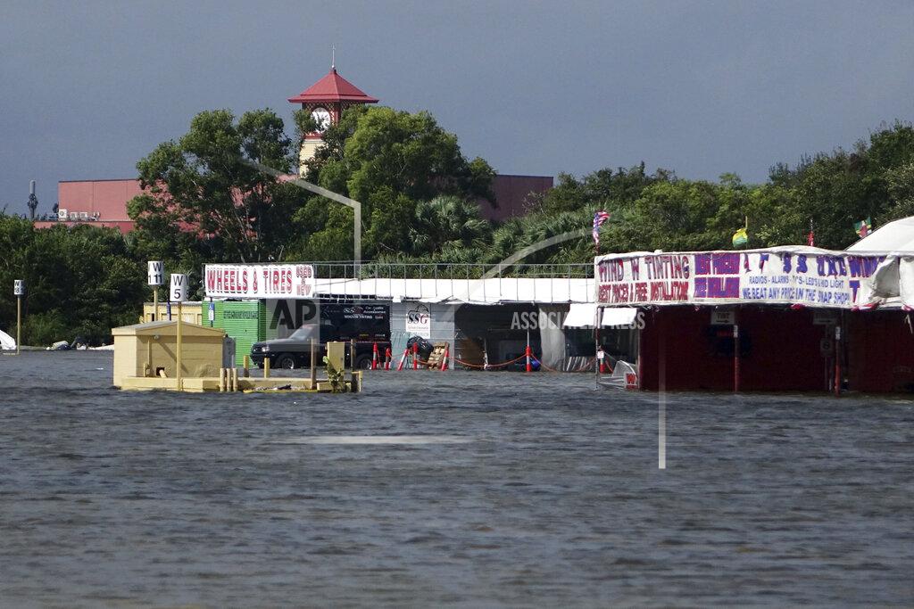 Joe Cavaretta The parking lot of the Sawp Shop Flea Market in Fort Lauderdale, Fla., is seen flooded, Monday, Nov. 9, 2020. Heavy rain from Tropical Storm Eta caused dangerous flooding Monday across Florida's most densely populated urban areas, stranding cars and swamping entire neighborhoods with fast-rising water that had no place to drain. (Joe Cavaretta/South Florida Sun-Sentinel via AP)