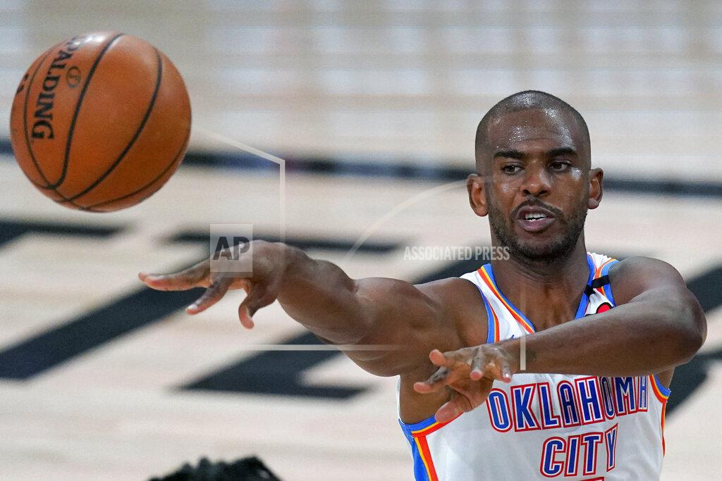 Mark J. Terrill FILE - Oklahoma City Thunder's Chris Paul (3) makes a pass during the first half of an NBA first-round playoff basketball game against the Houston Rockets in Lake Buena Vista, Fla., in this Wednesday, Sept. 2, 2020, file photo. A person with knowledge of the situation says All-Star guard Chris Paul is being traded from the Oklahoma City Thunder to the Phoenix Suns, where he'll play alongside one of the league's most dynamic young scorers in fellow All-Star Devin Booker. The Thunder are acquiring Ricky Rubio, Kelly Oubre, Jalen Lecque, Ty Jerome and a first-round pick that will be conveyed sometime between 2022 and 2025, said the person who spoke to The Associated Press on condition of anonymity because the trade had not been finalized by the league. (AP Photo/Mark J. Terrill, File)