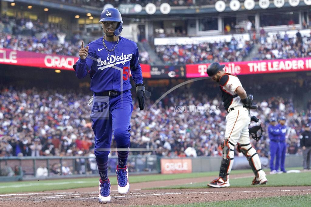 Jeff Chiu Los Angeles Dodgers' Mookie Betts, left, scores in front of San Francisco Giants catcher Curt Casali after pitcher Camilo Doval walked Will Smith with the bases during the fifth inning of a baseball game in San Francisco, Sunday, Sept. 5, 2021. (AP Photo/Jeff Chiu)