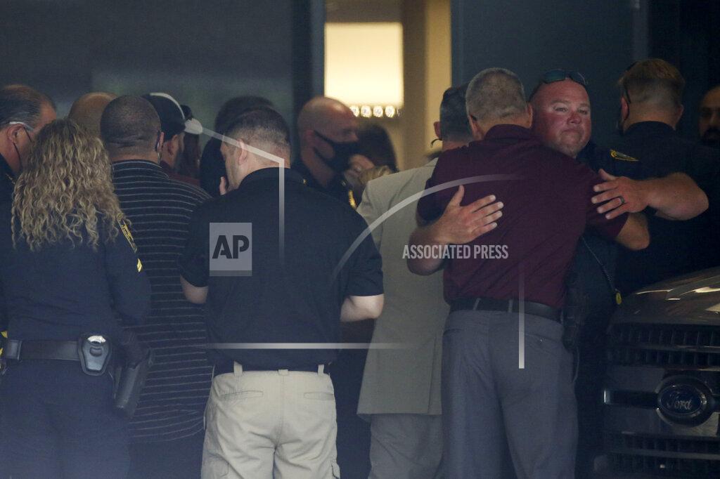 Yi-Chin Lee Police officers gather at the hospital where two Houston police officers were sent to after being shot while serving an arrest warrant on Monday, Sept. 20, 2021, at Memorial Hermann Hospital in Houston. Authorities say a Houston police officer was killed and another was wounded during a shooting that also killed a 31-year-old man who the officers were attempting to arrest. (Yi-Chin Lee/Houston Chronicle via AP)