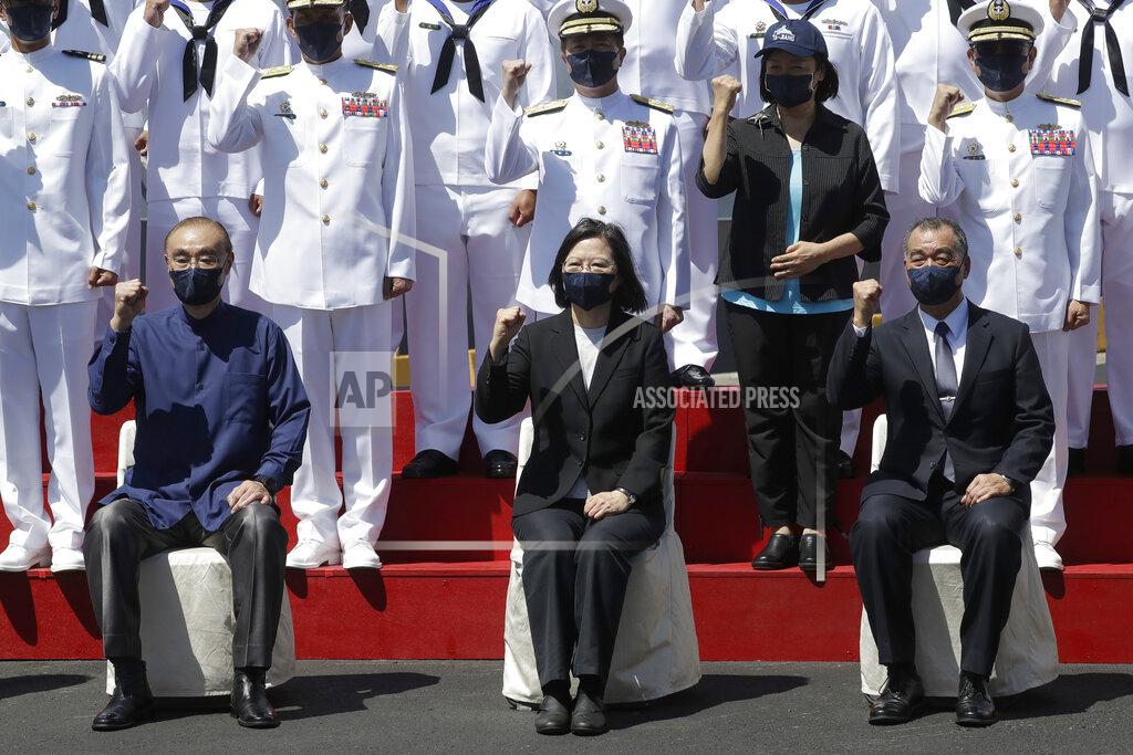 Chiang Ying-Ying Taiwan's President Tsai Ing-wen, center, cheers with officers during the commissioning ceremony of the the domestically made Ta Jiang warship at the Suao naval base in Yilan county, Taiwan, Thursday, Sept. 9, 2021. Taiwan's president oversaw the commissioning of the new domestically made navy warship Thursday as part of the island's plan to boost indigenous defense capacity amid heightened tensions with China. (AP Photo/Chiang Ying-ying)