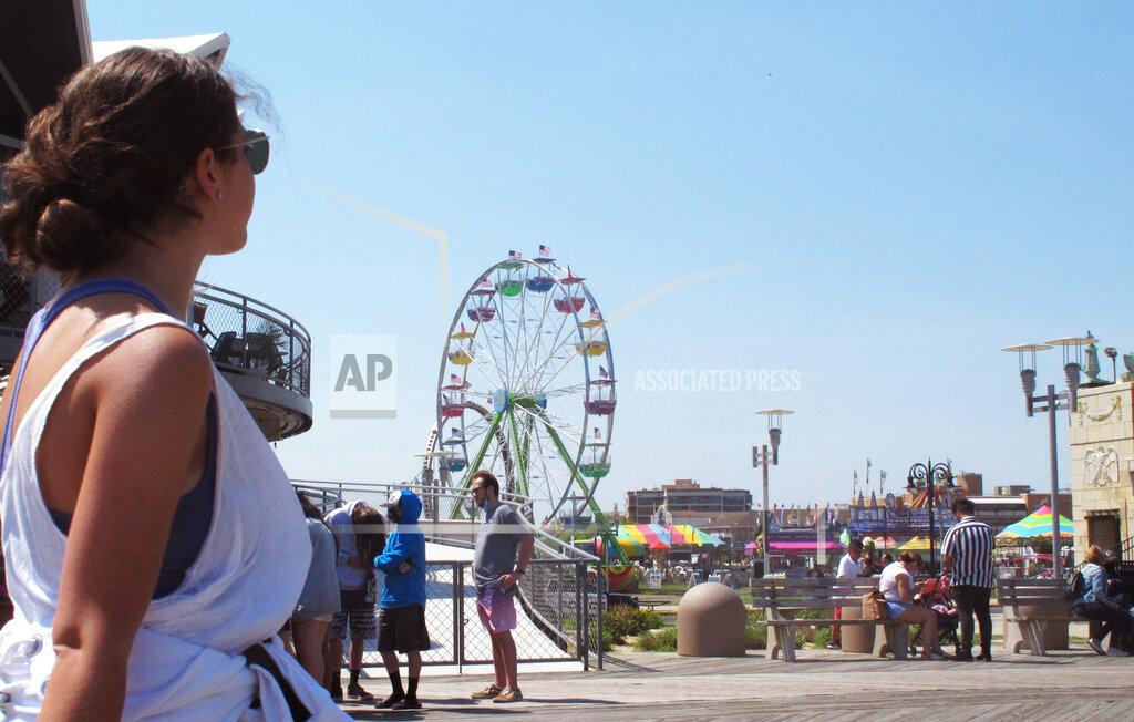 Wayne Parry A pedestrian walks on the boardwalk in Asbury Park N.J. on Friday, May 21, 2021. Businesses and residents alike expect this summer at the Jersey Shore to be busier than last year as more people get vaccinated and COVID19 restrictions are scaled back or eliminated. (AP Photo/Wayne Parry)