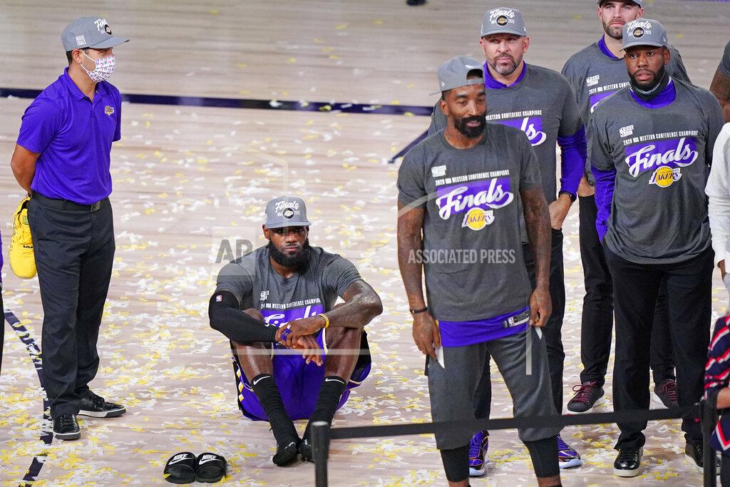 Mark J. Terrill Los Angeles Lakers' LeBron James sits on the floor as he waits for the trophy ceremony to start after the Lakers beat the Denver Nuggets in an NBA conference final playoff basketball game Saturday, Sept. 26, 2020, in Lake Buena Vista, Fla. The Lakers won 117-107 to win the series 4-1. (AP Photo/Mark J. Terrill)