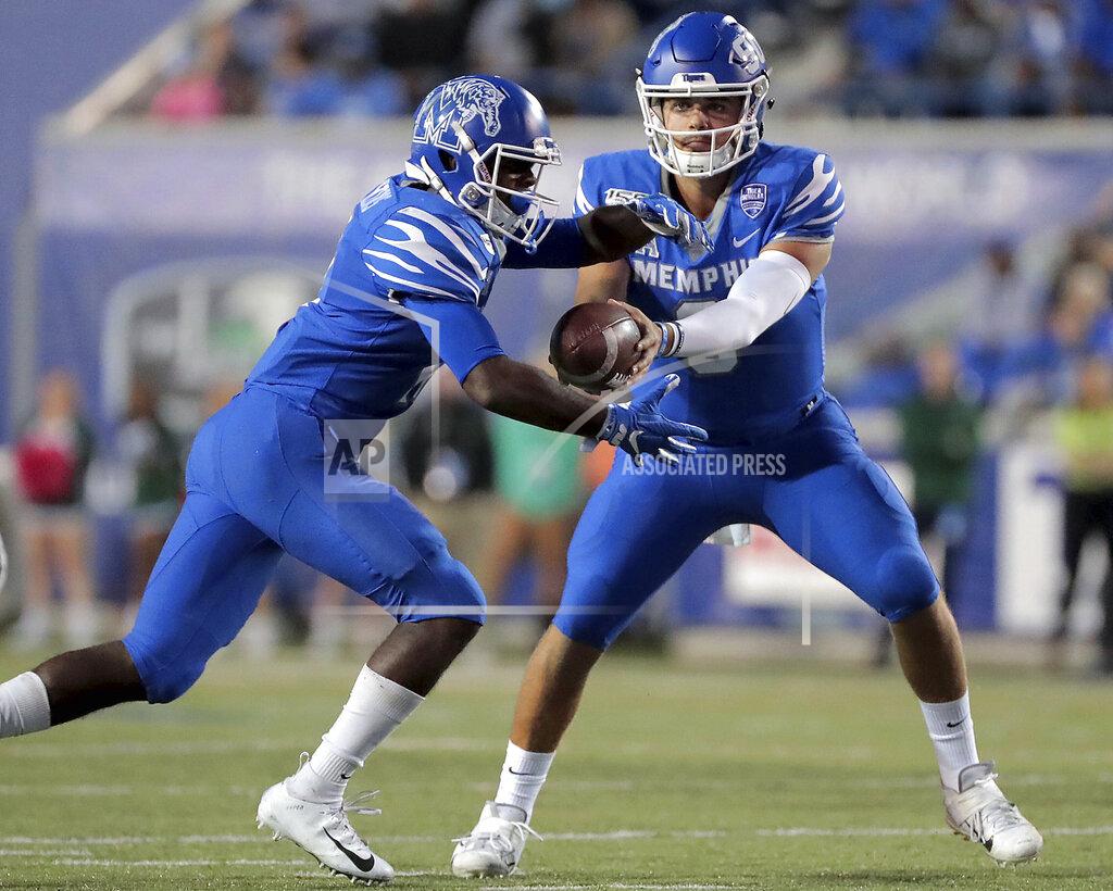 Jim Weber Memphis quarterback Brady White, right, shuffles the ball to running back Kylan Watkins during an NCAA college football game against Tulane on Saturday, Oct. 19, 2019, in Memphis, Tenn. (Jim Weber/Daily Memphian via AP)