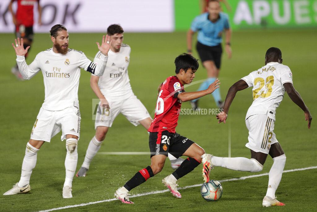Bernat Armangue Mallorca's Takefusa Kubo, center, vies for the ball with Real Madrid's Ferland Mendy, right, during the Spanish La Liga soccer match between Real Madrid and Mallorca at Alfredo di Stefano stadium in Madrid, Spain, Wednesday, June 24, 2020. (AP Photo/Bernat Armangue)