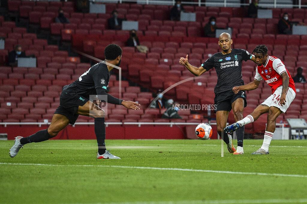 Glyn Kirk Arsenal's Reiss Nelson, right, scores his team second goal during the English Premier League soccer match between Arsenal and Liverpool at the Emirates Stadium in London, England, Wednesday, July 15, 2020. (Glyn Kirk/Pool via AP)