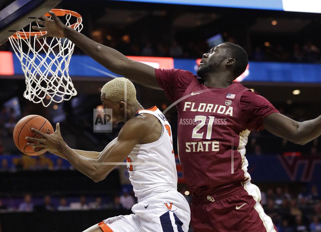 Chuck Burton Virginia's Mamadi Diakite, left, drives past Florida State's Christ Koumadje, right, during the first half of an NCAA college basketball game in the Atlantic Coast Conference tournament in Charlotte, N.C., Friday, March 15, 2019. (AP Photo/Chuck Burton)