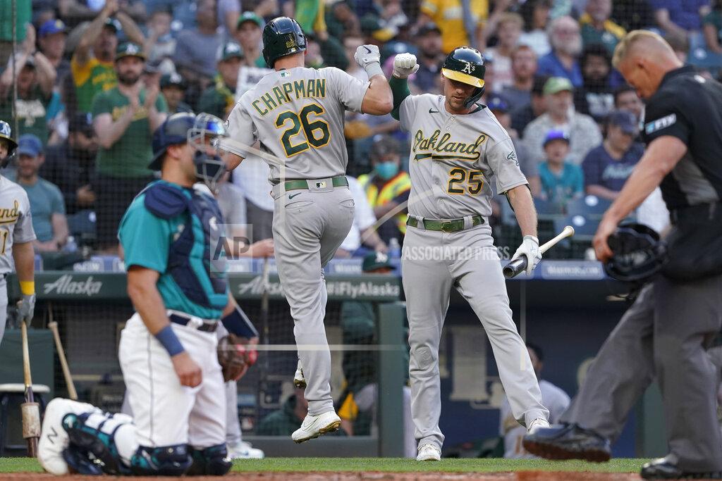 Ted S. Warren Oakland Athletics' Matt Chapman (26) greets Stephen Piscotty (25) after Chapman hit a solo home run during the third inning of the team's baseball game against the Seattle Mariners, Friday, July 23, 2021, in Seattle. (AP Photo/Ted S. Warren)