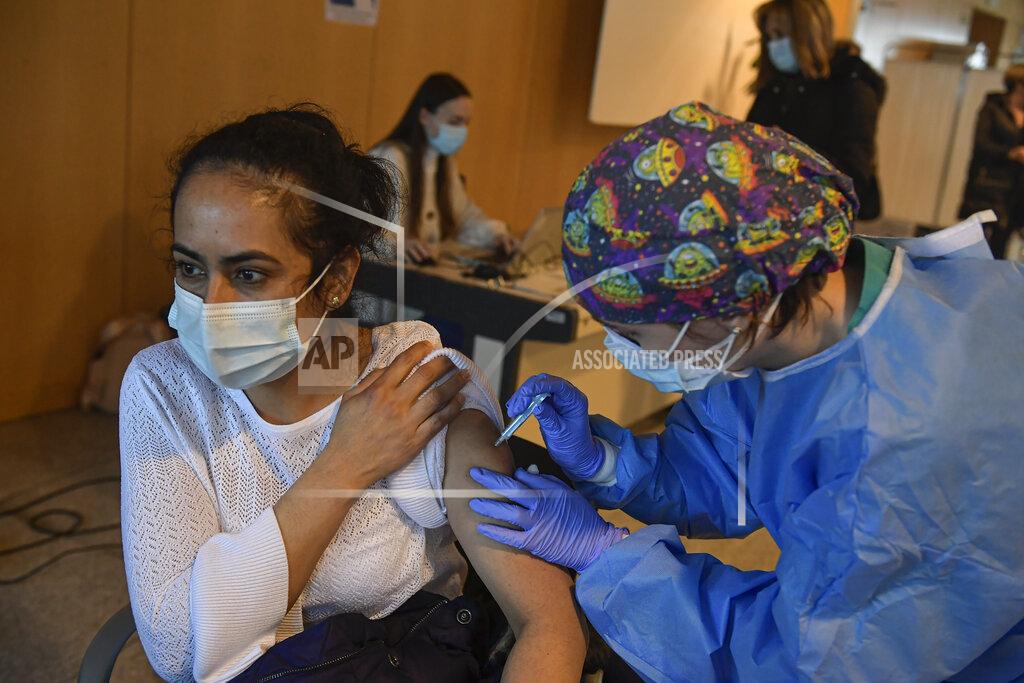 Alvaro Barrientos A woman receives a dose of the AstraZeneca COVID-19 vaccine, during a mass vaccination campaign at San Pedro Hospital, in Logrono, northern Spain, Wednesday, March 24, 2021. Spain resumed the use of the AstraZeneca vaccine on Wednesday. (AP Photo/Alvaro Barrientos)