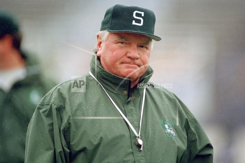 Beth A. Keiser FILE - In this Nov. 5, 1994, file photo, Michigan State coach George Perles watches his team warm up before an NCAA college football game against Northwestern, in Evanston, Ill. Perles, who coached Michigan State to a Rose Bowl victory in 1988 and was a key defensive assistant for the dominant Pittsburgh Steelers teams of the 1970s, died Tuesday, Jan. 7, 2020. He was 85. (AP Photo/Beth A. Keiser, File)