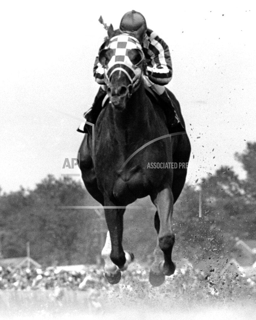 Uncredited FILE - In this May 5, 1973, file photo, jockey Ron Turcotte rides Secretariat to victory in the Kentucky Derby horse race at Churchill Downs in Louisville, Ky. Secretariat is the early 7-2 favorite for this weekend’s virtual Kentucky Derby, an animated race pitting all 13 Triple Crown winners on the day the Derby would have been held before the coronavirus pandemic postponed it.(AP Photo/File)