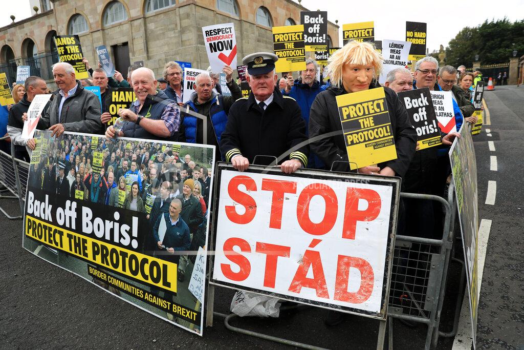 Peter Morrison Demonstrators protest outside Hillsborough Castle, ahead of a visit by British Prime Minister Boris Johnson, in Hillsborough, Northern Ireland, Monday, May, 16, 2022. Johnson on Monday renewed British threats to break a Brexit agreement with the European Union, blaming it for a political crisis that's blocking the formation of a new government in Northern Ireland. (AP Photo/Peter Morrison)