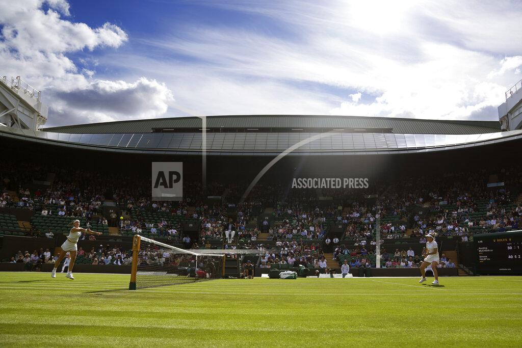 Alastair Grant Karolina Muchova of the Czech Republic, left, returns the ball to Romania's Simona Halep in a singles tennis match on day two of the Wimbledon tennis championships in London, Tuesday, June 28, 2022. (AP Photo/Alastair Grant)