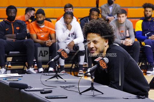 Sue Ogrocki With his teammates looking on at rear, Cade Cunningham announces that he will enter the NBA draft after a dynamic freshman season that saw him named a first-team AP All-American, Thursday, April 1, 2021, in Stillwater, Okla. (AP Photo/Sue Ogrocki)