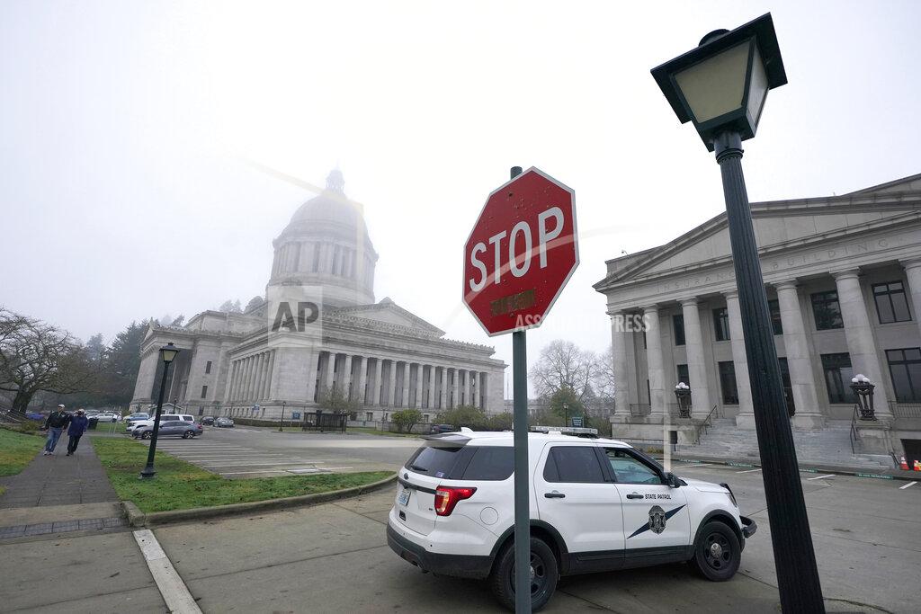 A Washington State Patrol vehicle patrols Thursday, Jan. 7, 2021, at the Capitol in Olympia, Wash., the day after supporters of President Donald Trump protested in Olympia against the counting of electoral votes in Washington, DC to affirm President-elect Joe Biden's victory. The Washington Legislature's 2021 session is scheduled to open on Monday, Jan. 11, 2021. (AP Photo/Ted S. Warren)